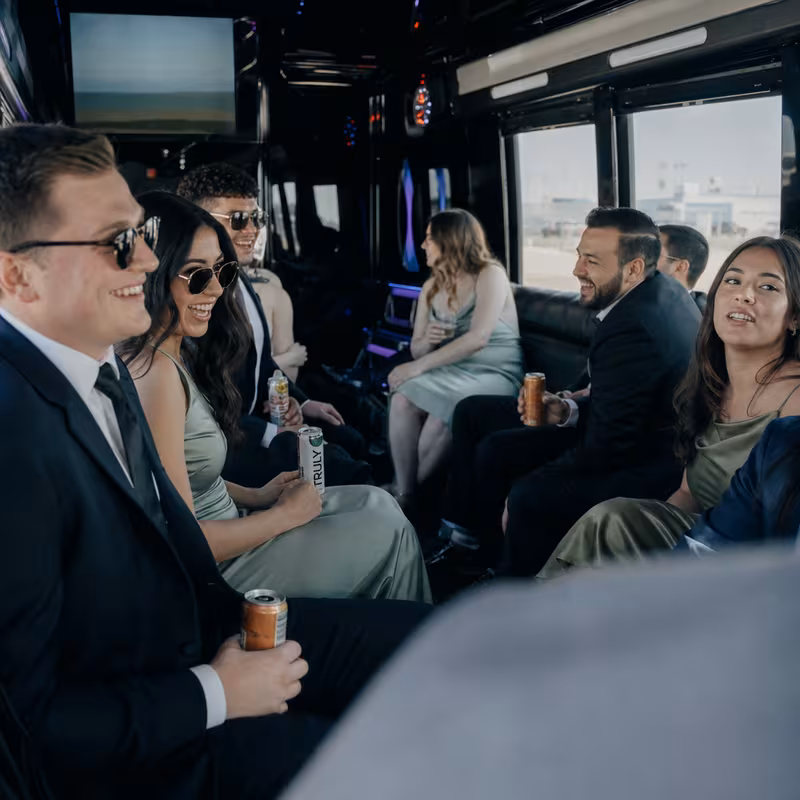 Wedding guests seated inside a Salinas party bus