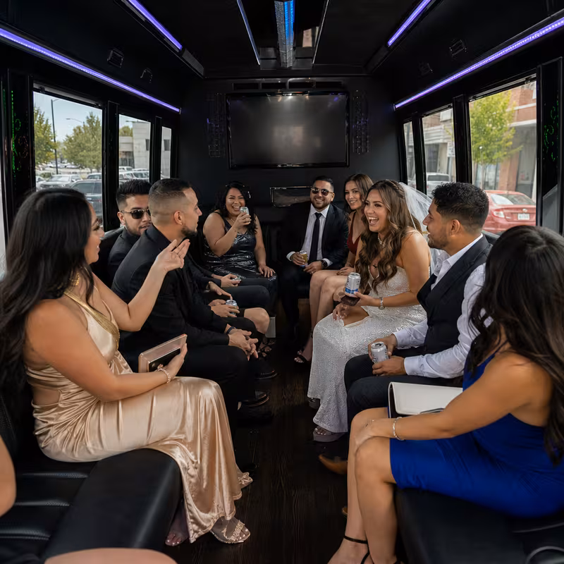 Party bus interior with wraparound leather seating and LED lighting in Salinas