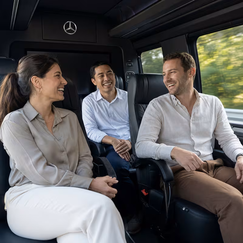 Group boarding a white charter bus for Corporate Transportation transportation in Salinas