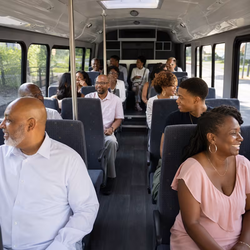 Group boarding a white charter bus for Private Event Transportation transportation in Salinas
