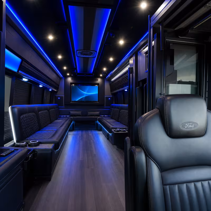 Party bus interior with wraparound leather seating and LED lighting in Salinas