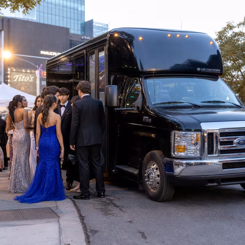 Passengers loading luggage while boarding an Salinas group shuttle