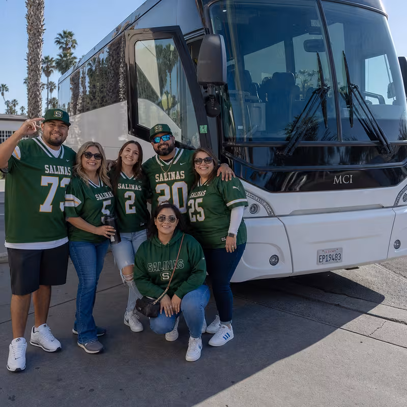 Passengers loading luggage while boarding an Salinas group shuttle