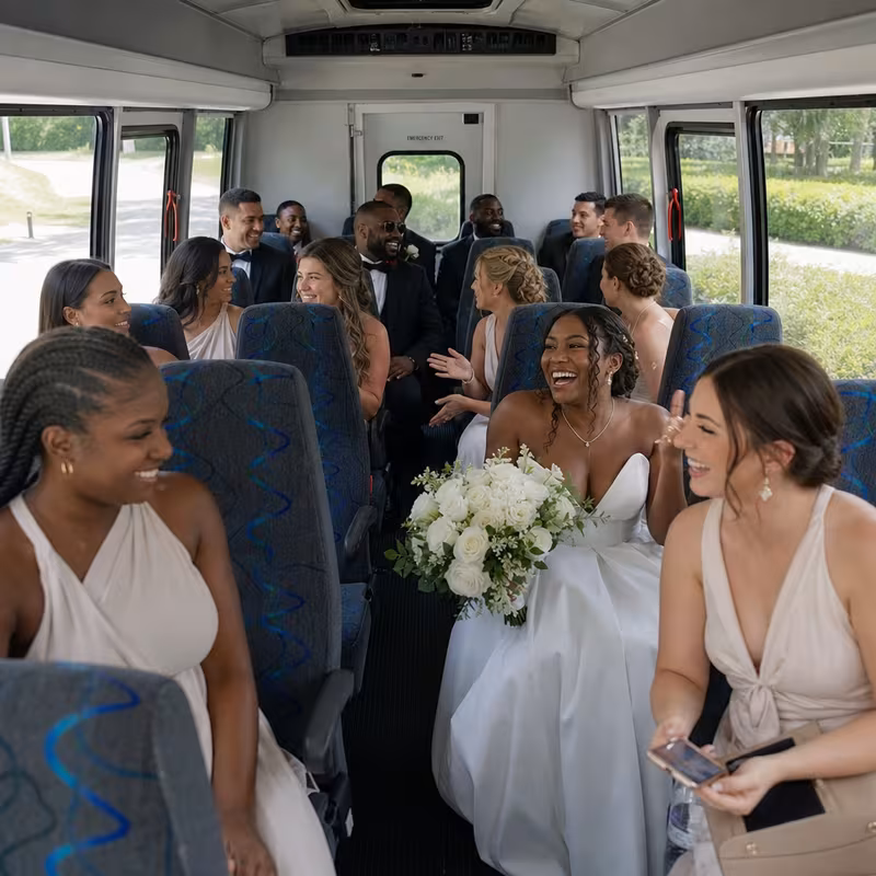 Group boarding a white charter bus for Wedding Transportation transportation in Salinas