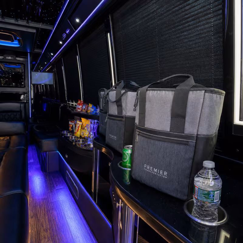 Party bus interior with wraparound leather seating and LED lighting in Salinas